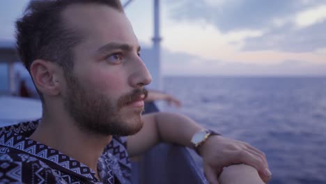 The-young-man-traveling-on-the-ship-watches-the-sea.